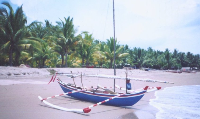 Out-rigger Fishing boat on beach near Padang on Sumatra